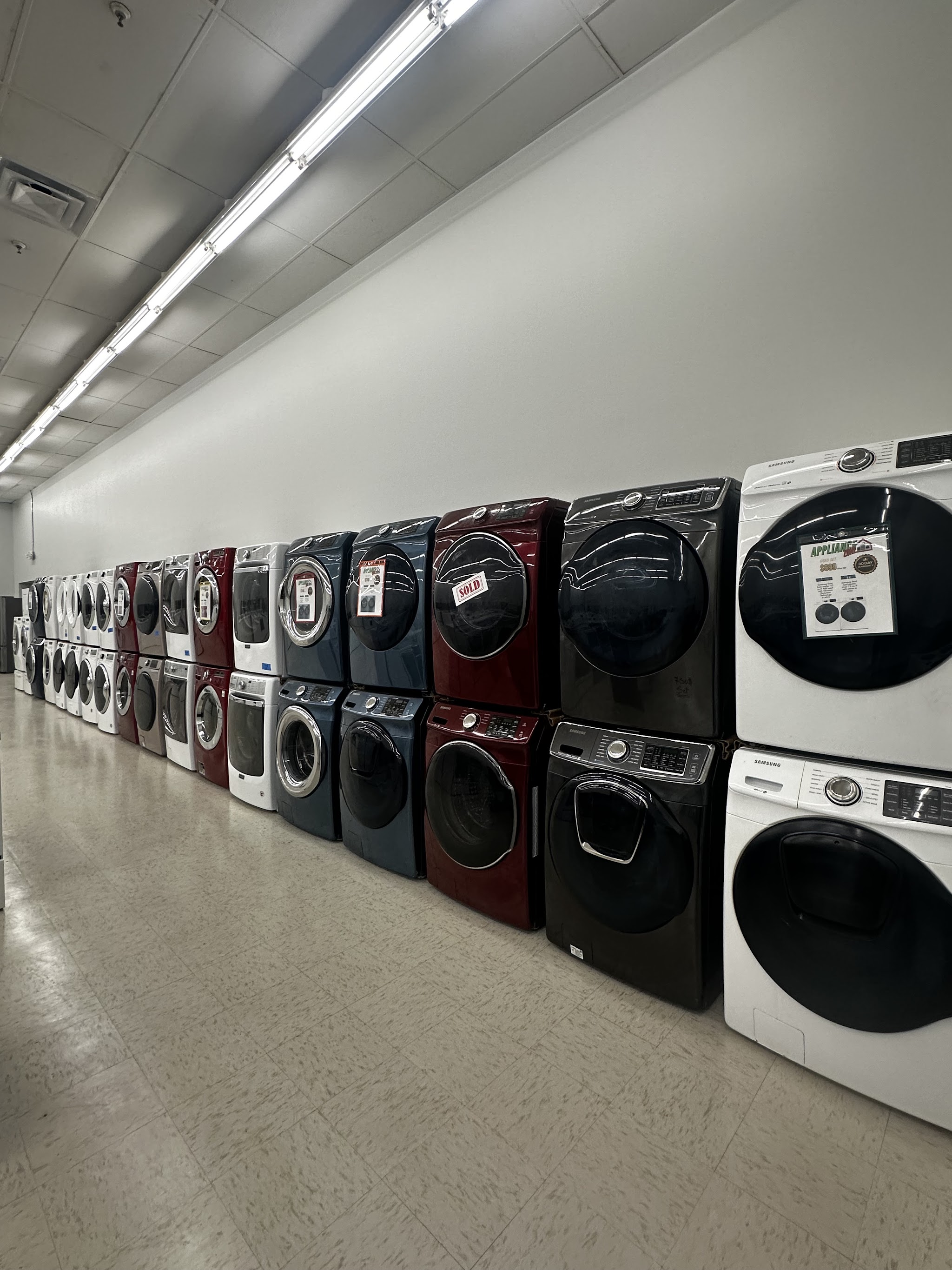 A long row of front-load washers and dryers